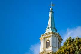 The spire of Cochran Chapel against a blue sky