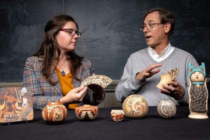 Marla Taylor and Ryan Wheeler holding 17th-century sherds