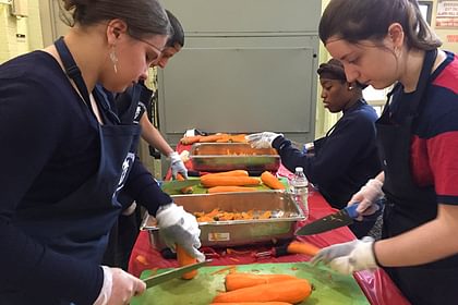 students helping with food preparation at Pine Street Inn