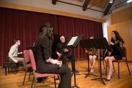 student and faculty performing in Graves