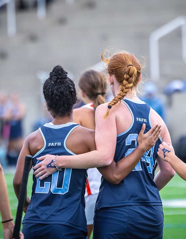 Andover field hockey players embrace after a goal