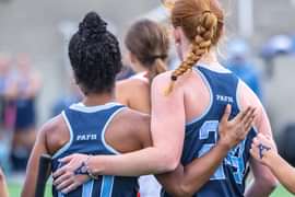 Andover field hockey players embrace after a goal