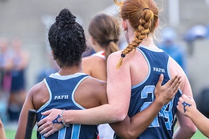 Andover field hockey players embrace after a goal
