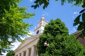 Samuel Phillips Hall with blue sky and trees