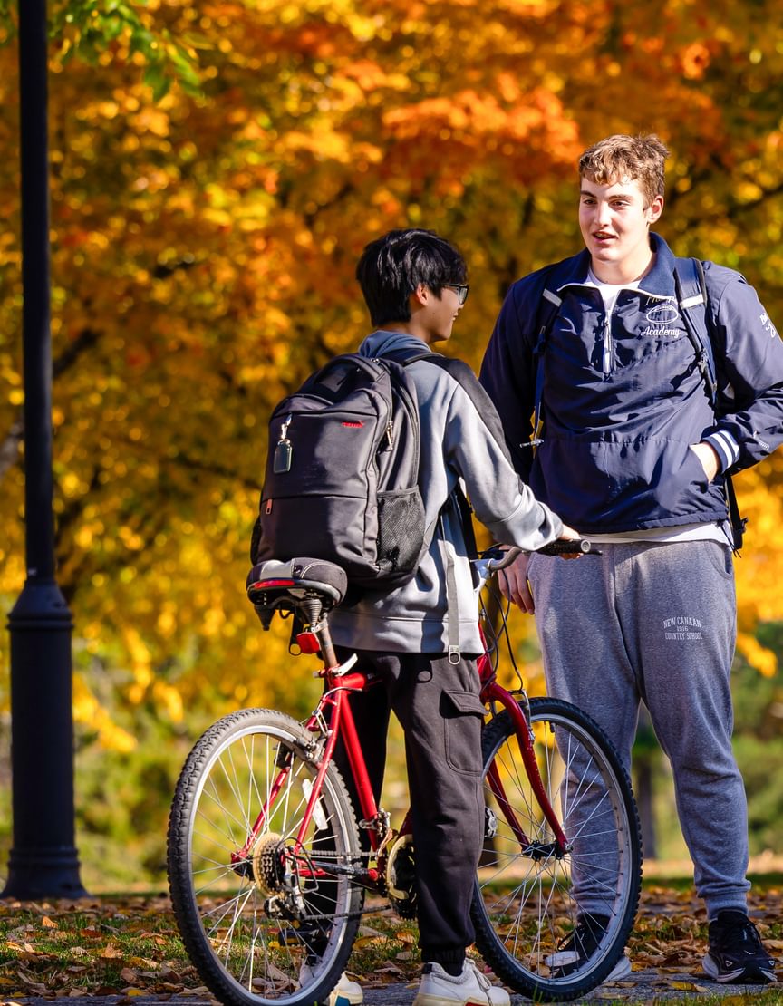 Two Andover students on campus with fall foliage