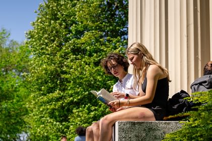 Students gather and read on the steps of Samuel Phillips Hall