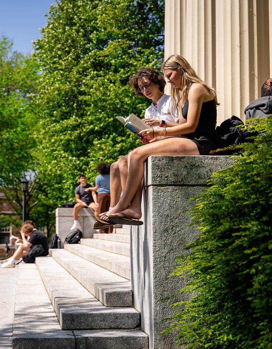 Students gather and read on the steps of Samuel Phillips Hall