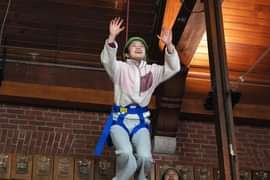 Student smiling while exploring the ropes course