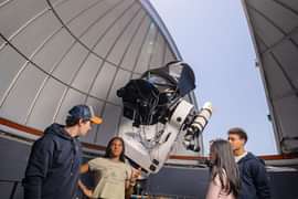 Faculty and students discuss astronomy at the Gelb observatory