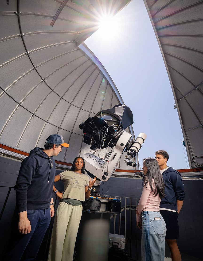 Faculty and students discuss astronomy at the Gelb observatory