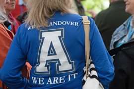 Woman wearing an Andover shirt stands with her back to the camera