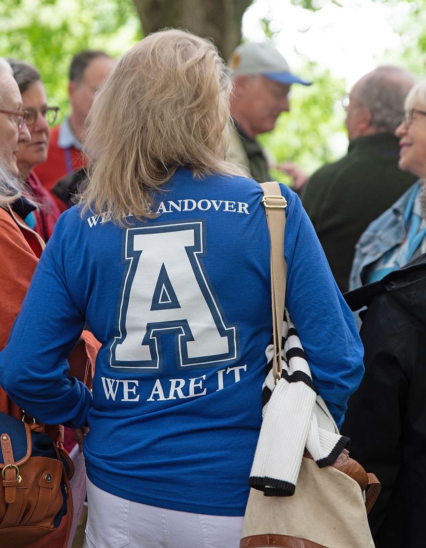 Woman wearing an Andover shirt stands with her back to the camera