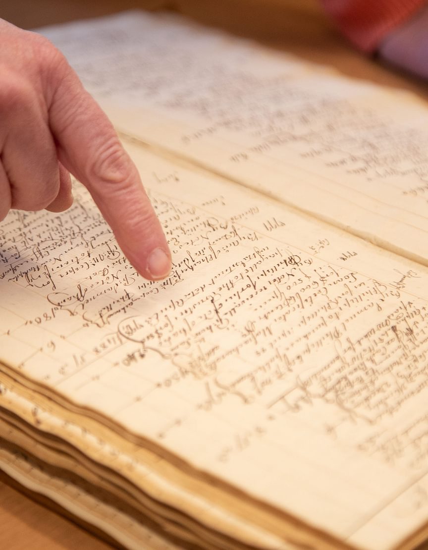 A finger pointing at a ledger from 1881