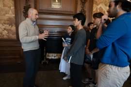 Josh Steiner in mural room talking with students