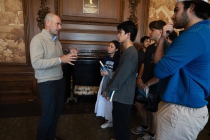 Josh Steiner in mural room talking with students