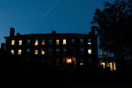 outside a dorm with lights on at night